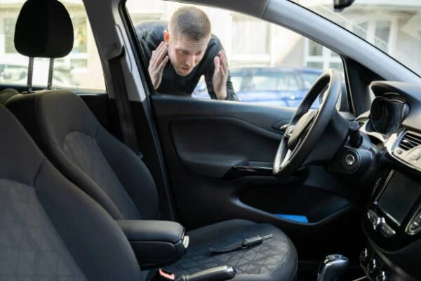 Towing Company experts trying to help a man with a car key lockout problem